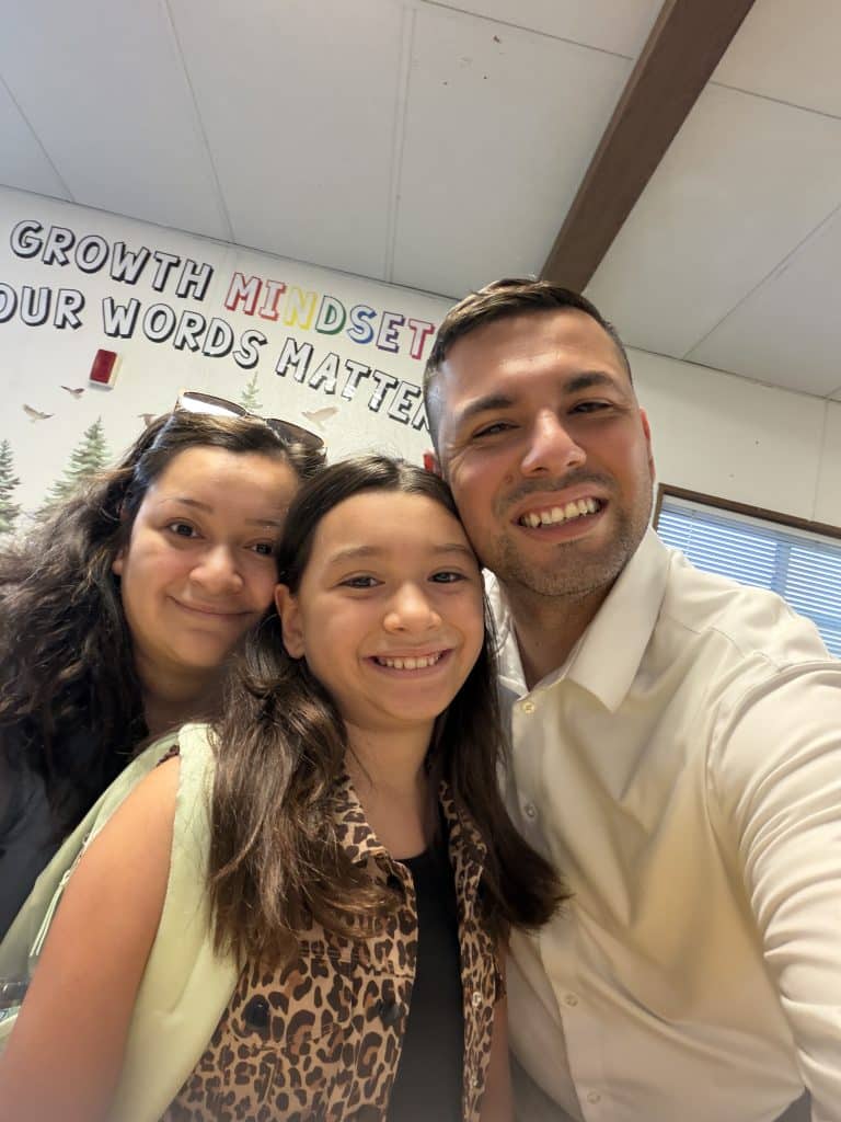 Joel Campos with his wife and daughter at a school event